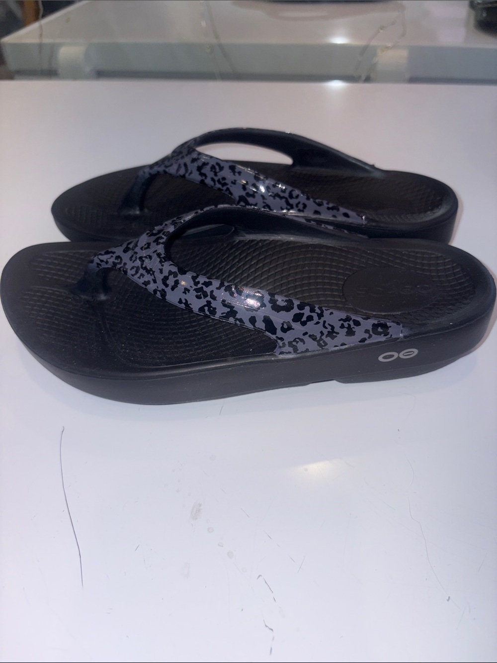 OOFOS Black Flip Flop Sandals with Gray Leopard-Print Straps